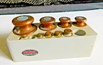 Antique Collectable Ohaus Set Of 9 Graduated Brass Weights In Plastic Block. Fixed Price $48.00.